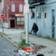 Martha Wallace, 35, takes a pleasant stroll down one of the neighborhood's dimly lit, trash-strewn streets.